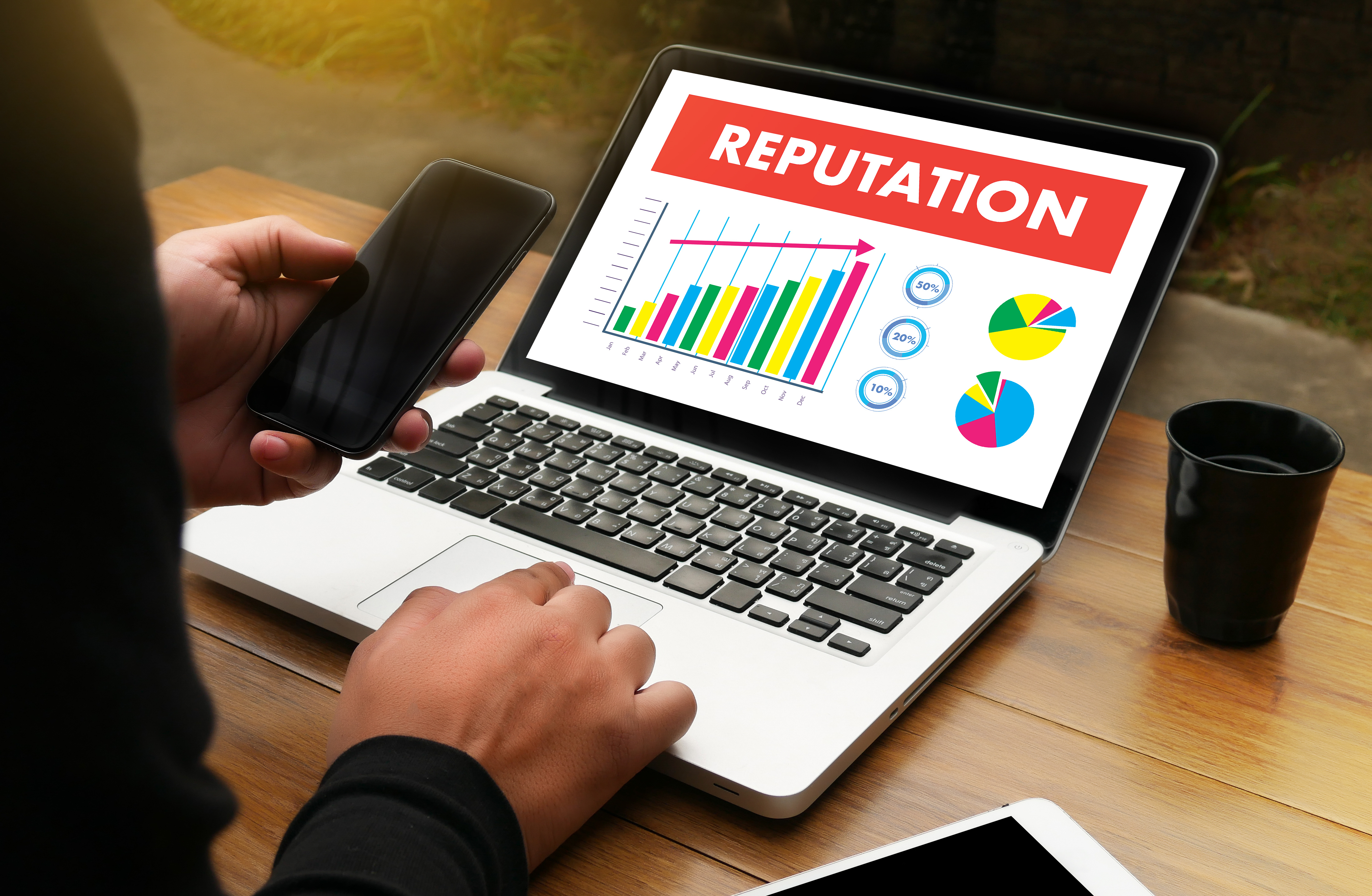 person using a computer showing their reputation going up in a chart